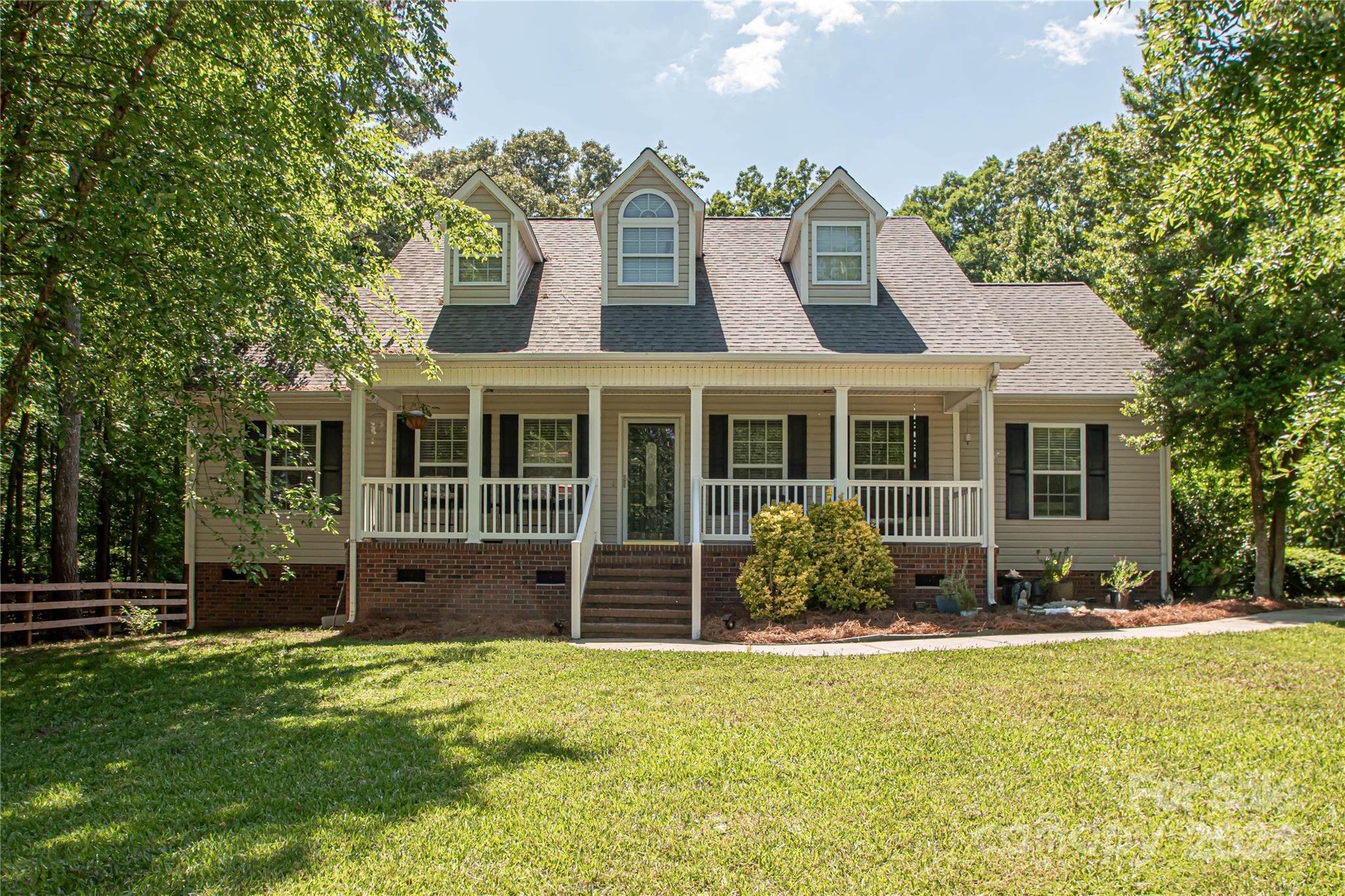 a front view of a house with a garden