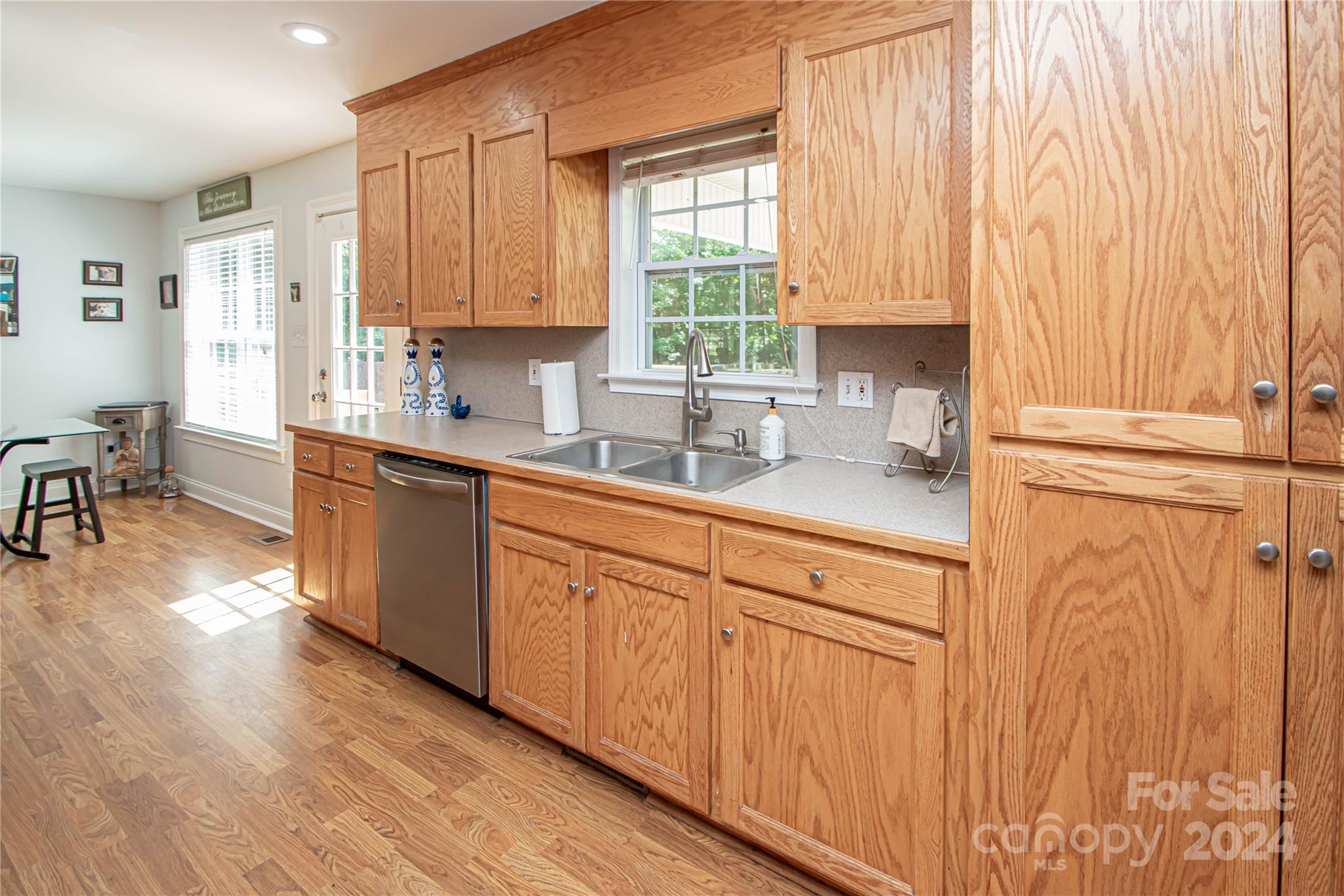 1641 Logan Terry Road Lancaster, SC 29720 - Photo 25 of 45 a kitchen with stainless steel appliances granite countertop white cabinets a sink and dishwasher with wooden floor