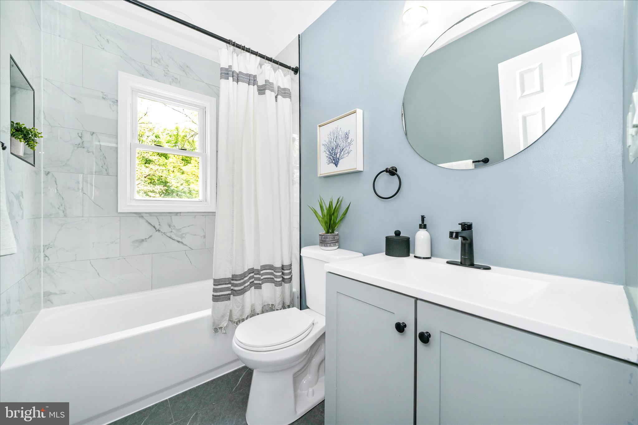 6737 Allentown Road Temple Hills, MD 20748 - Photo 48 of 51 a bathroom with a sink a toilet and a mirror