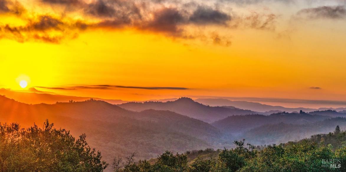 a view of an ocean with a mountain