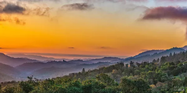 an aerial view of mountain with an ocean