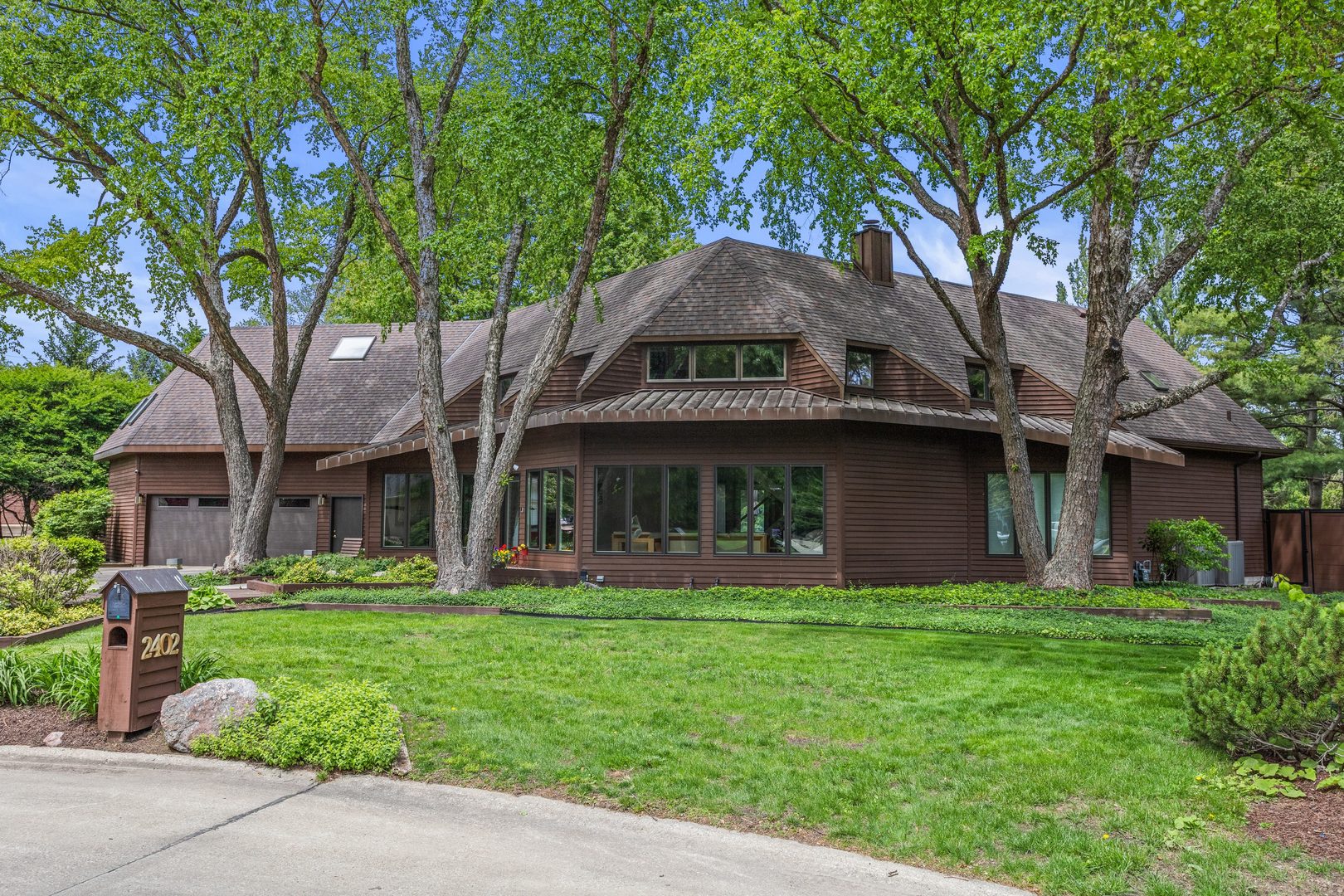 2402 North Nottingham Court Champaign, IL 61821 - Photo 1 of 64 a front view of a house with a garden