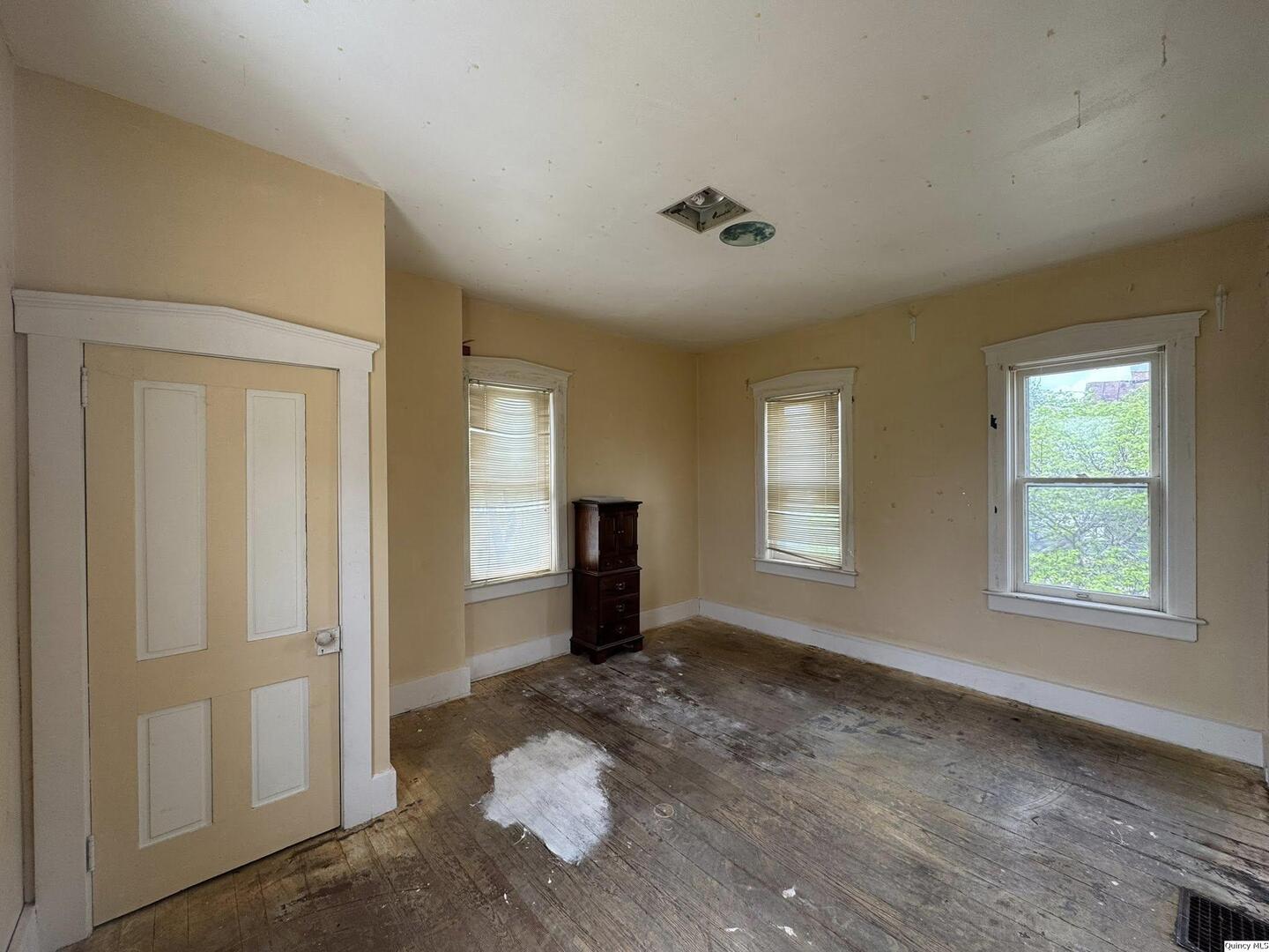 608 Adams Street Quincy, IL 62301 - Photo 11 of 19 a view of wooden floor and windows in a room