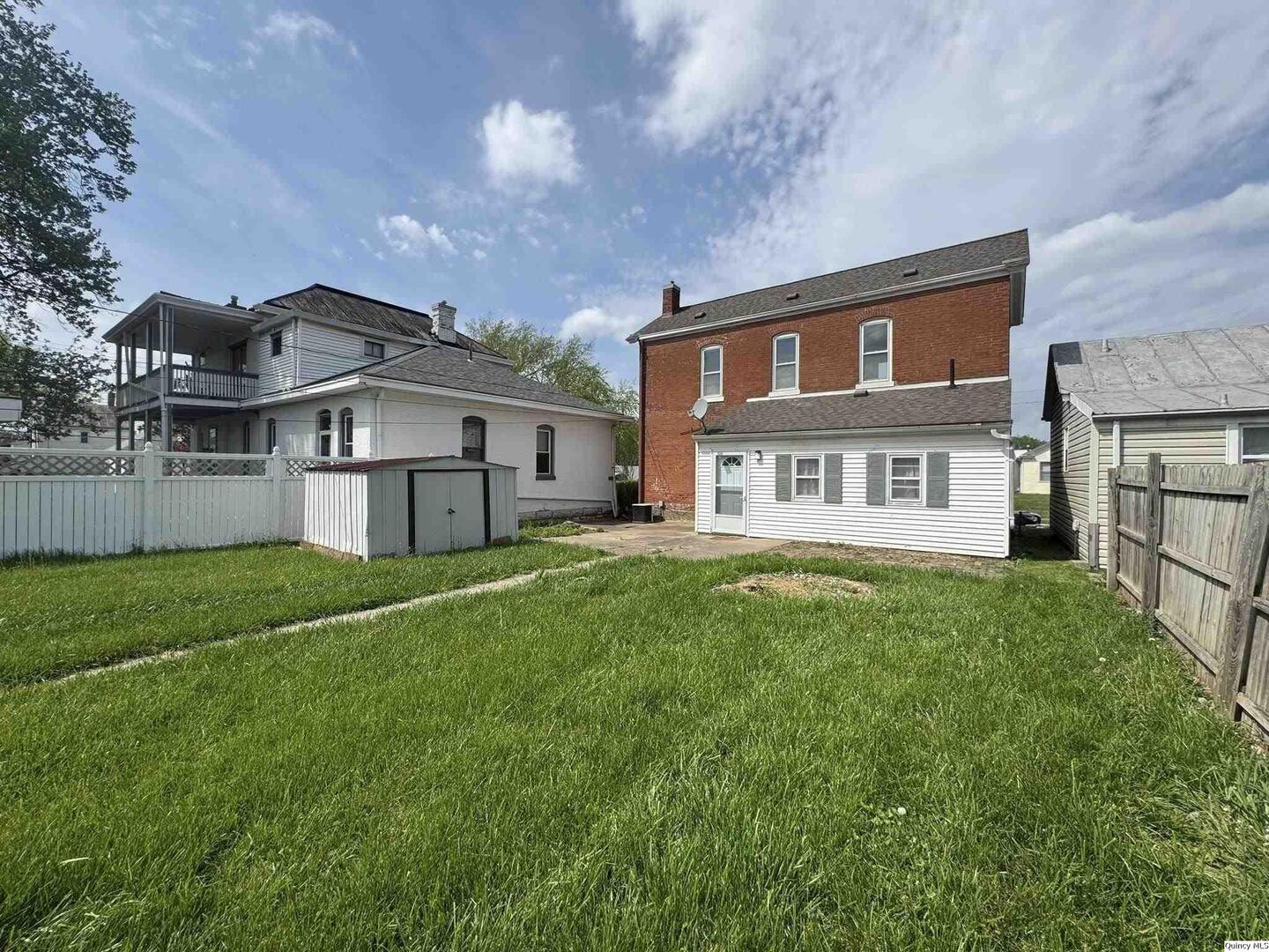608 Adams Street Quincy, IL 62301 - Photo 17 of 19 a front view of a house with a yard and trees