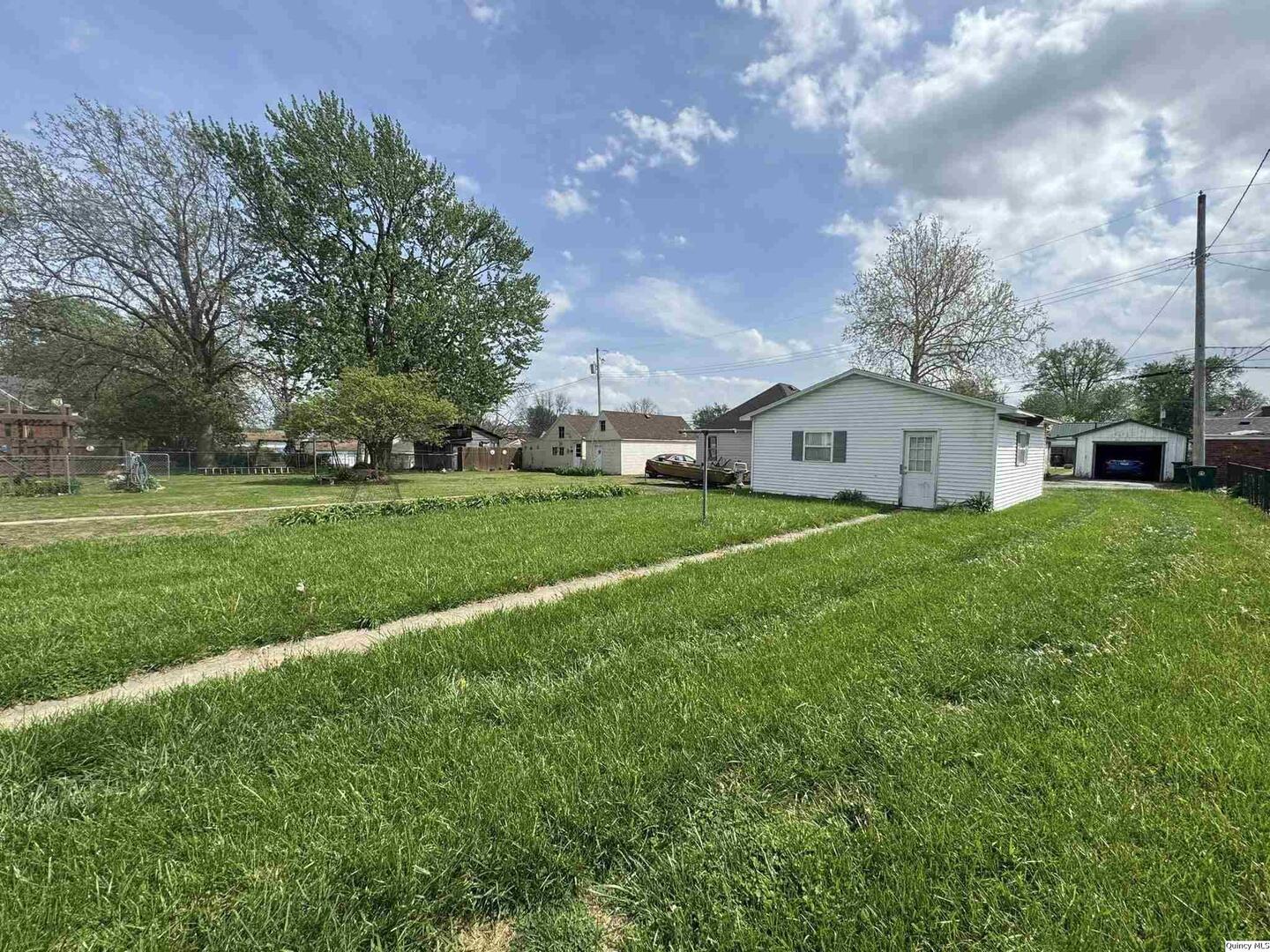 608 Adams Street Quincy, IL 62301 - Photo 18 of 19 a view of a house with a big yard