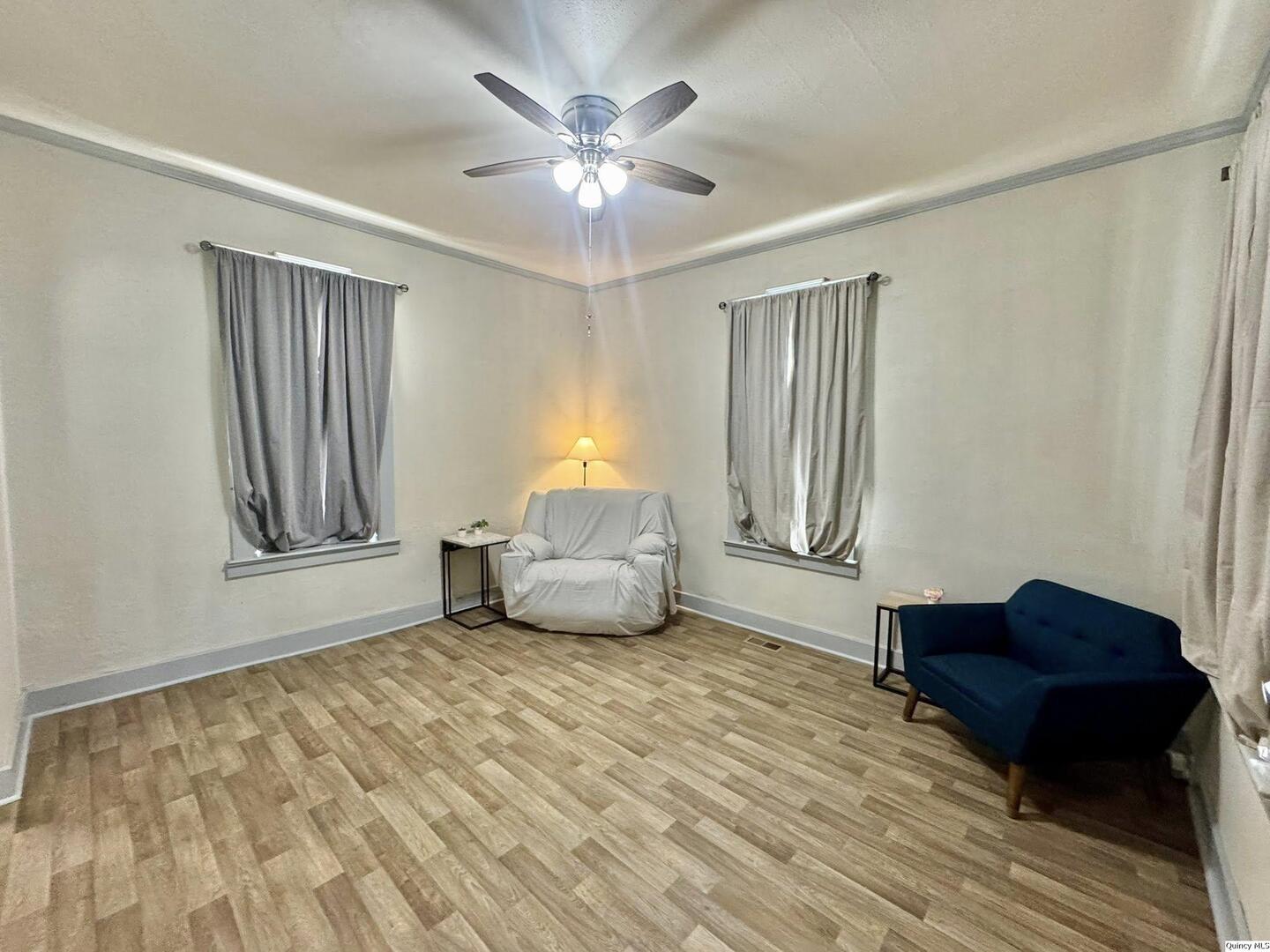 608 Adams Street Quincy, IL 62301 - Photo 2 of 19 a living room with furniture and a window