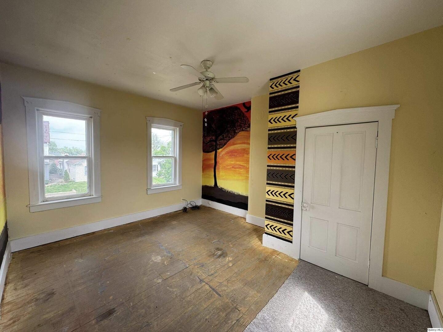 608 Adams Street Quincy, IL 62301 - Photo 9 of 19 a view of an empty room with a window and fireplace