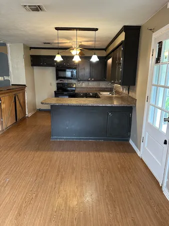 a view of a living room with wooden floor
