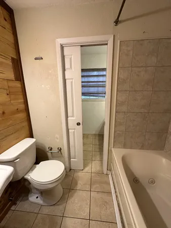 a bathroom with a bathtub and a toilet