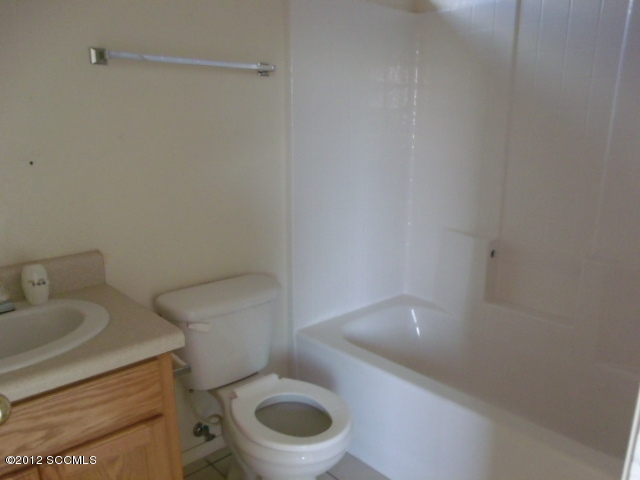 585 Yak Lane Rio Rico, AZ 85648 - Photo 8 of 11 a white toilet sitting next to a bathroom sink