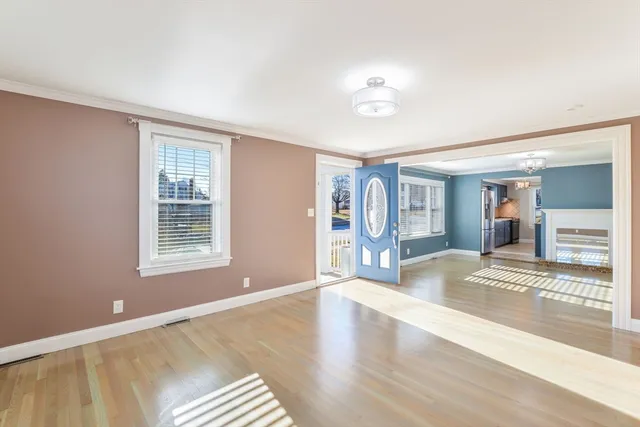 a view of a livingroom with wooden furniture and windows