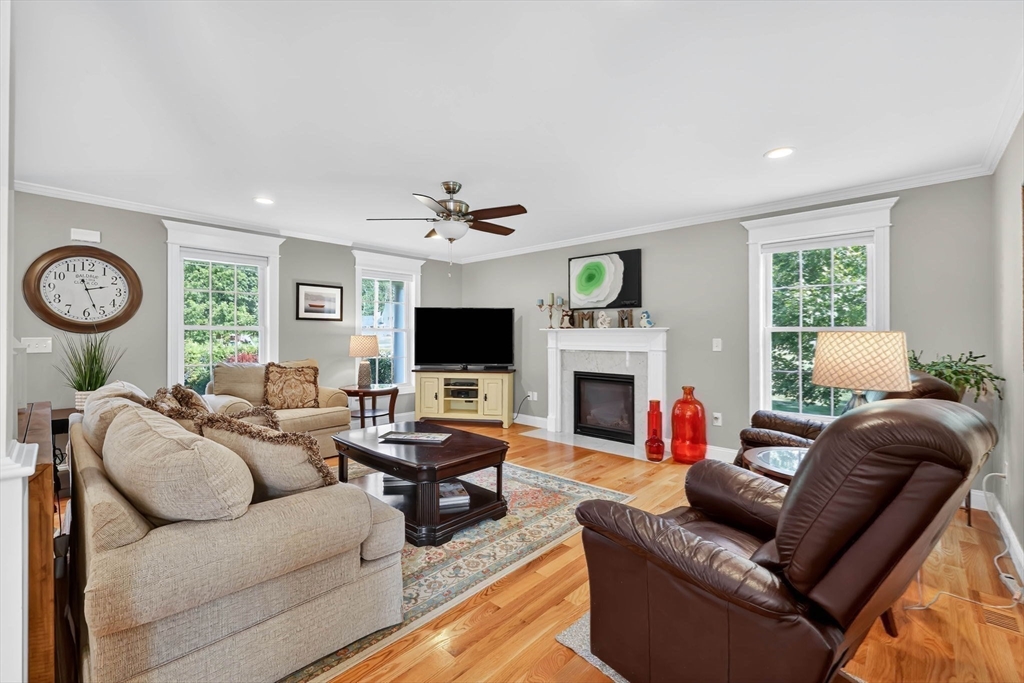 21 Monson Road Wilbraham, MA 01095 - Photo 8 of 42 a living room with furniture a fireplace and a flat screen tv