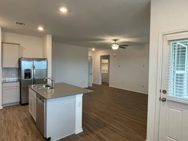 a view of a backyard with plants and lake view