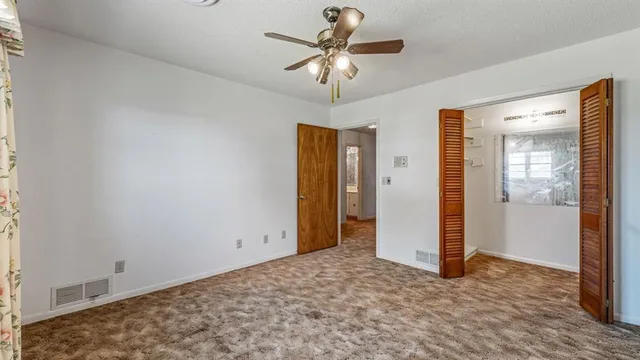 a view of a livingroom with a chandelier fan
