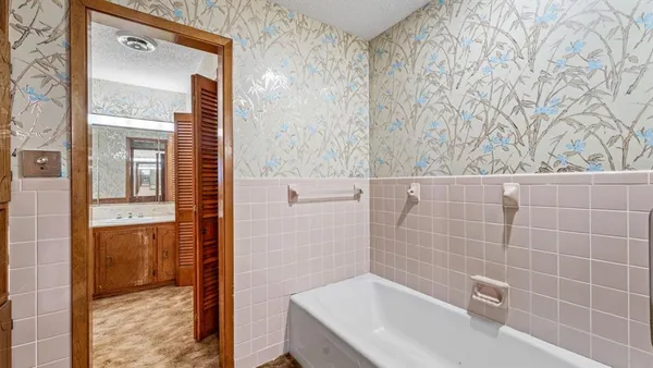 a bathroom with a bathtub and shower