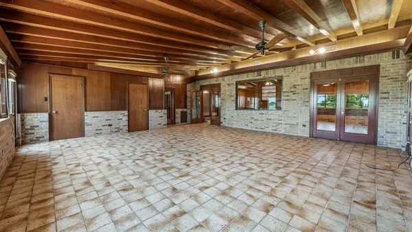 a view of a hall with wooden floor