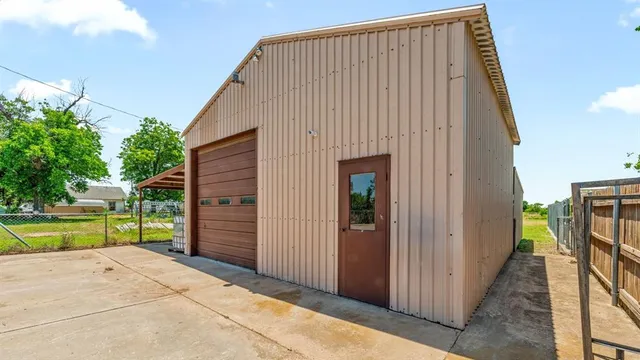 a view of a backyard with wooden fence