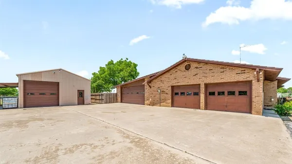 a view of a house with a yard and garage