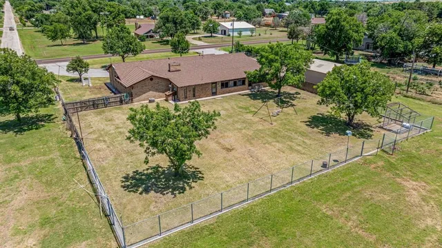 an aerial view of a house with a yard