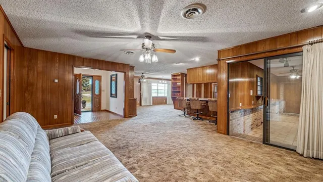 a view of a livingroom with furniture and a ceiling fan