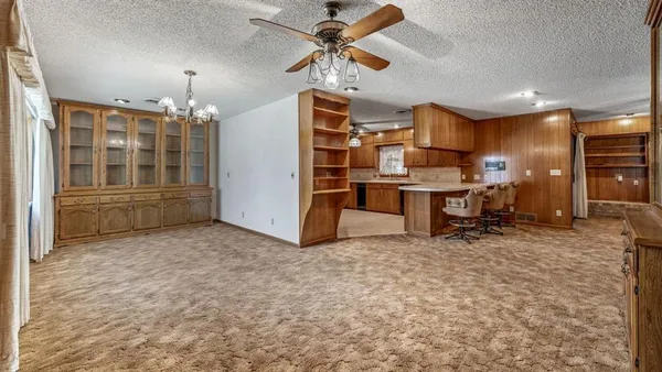 a view of a livingroom with furniture and a ceiling fan