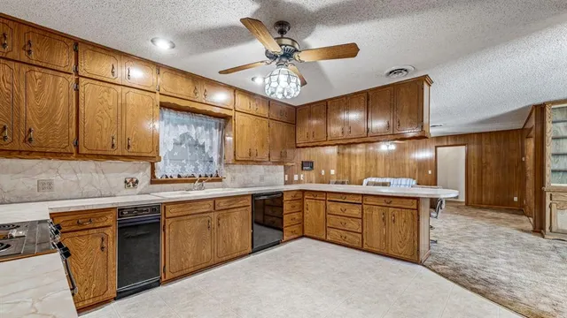 a kitchen with lots of counter space sink and a mirror
