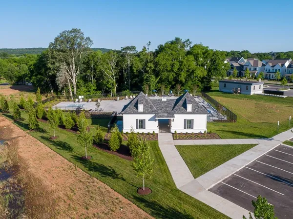 a view of house with garden and a sitting area