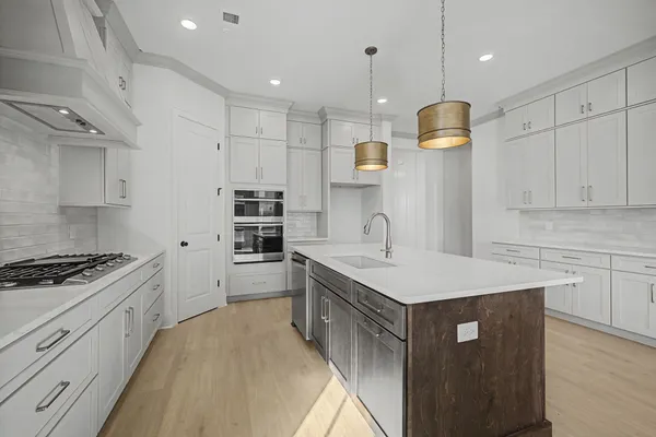 a kitchen with a sink stove and refrigerator