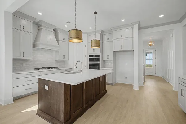 a kitchen with a sink stove and cabinets