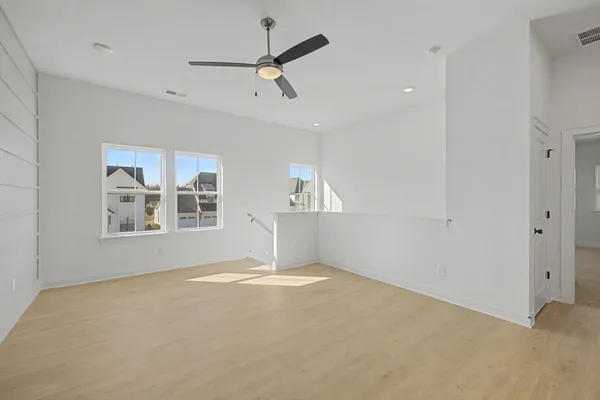 a view of a porch with furniture and floor to ceiling window