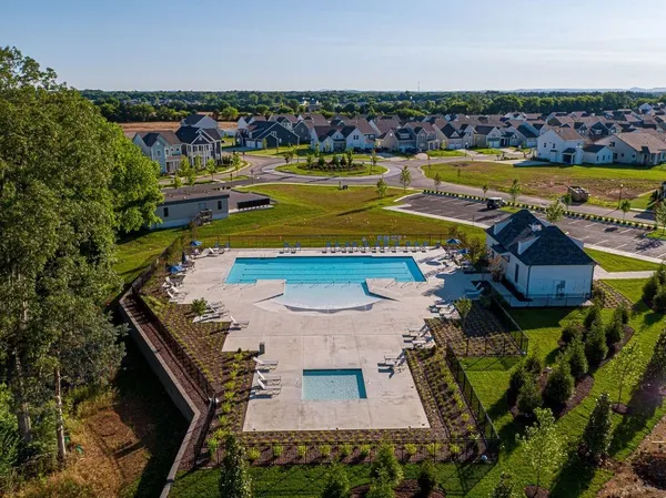 an aerial view of a house with a swimming pool outdoor seating and yard