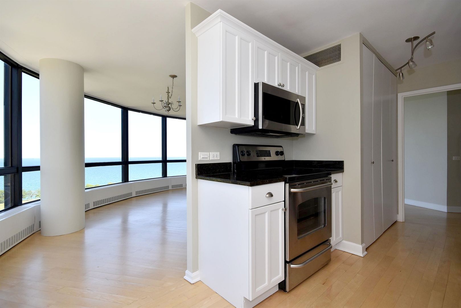 5415 North Sheridan Road, Unit 1806 Chicago, IL 60640 - Photo 11 of 38 a kitchen with stainless steel appliances a stove microwave and sink
