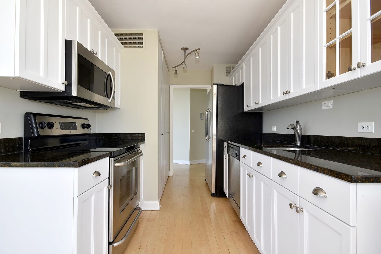 5415 North Sheridan Road, Unit 1806 Chicago, IL 60640 - Photo 13 of 38 a kitchen with stainless steel appliances a sink a stove and microwave