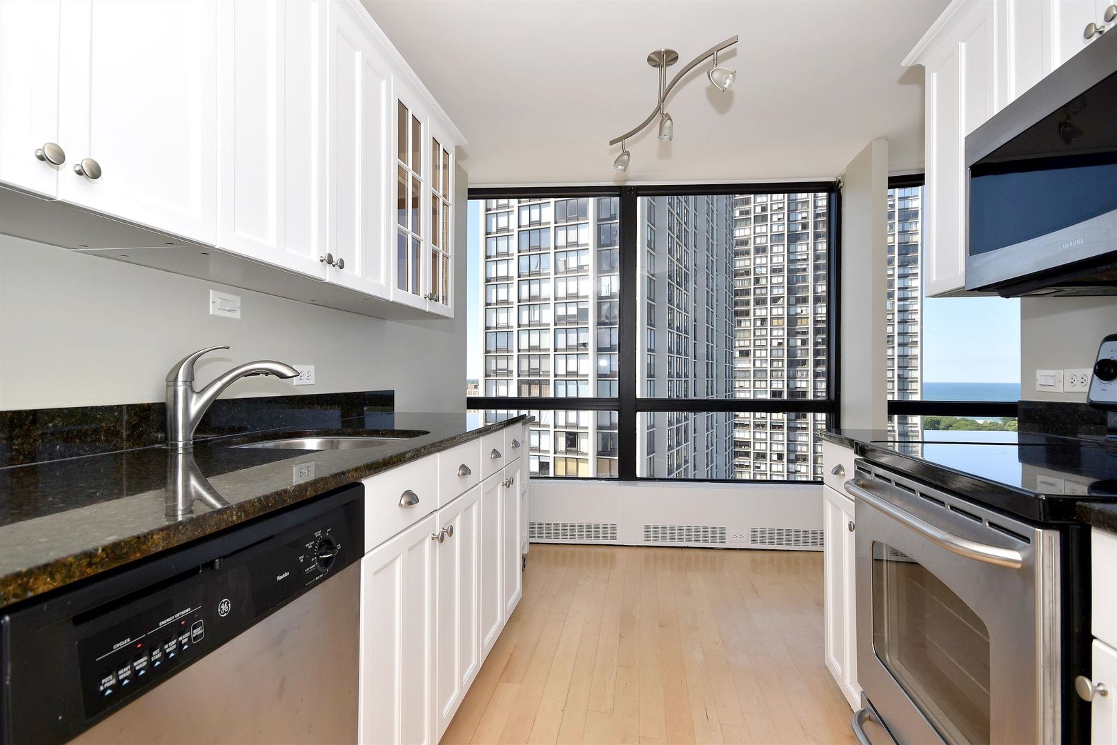 5415 North Sheridan Road, Unit 1806 Chicago, IL 60640 - Photo 14 of 38 a kitchen with stainless steel appliances granite countertop a stove a sink and a microwave