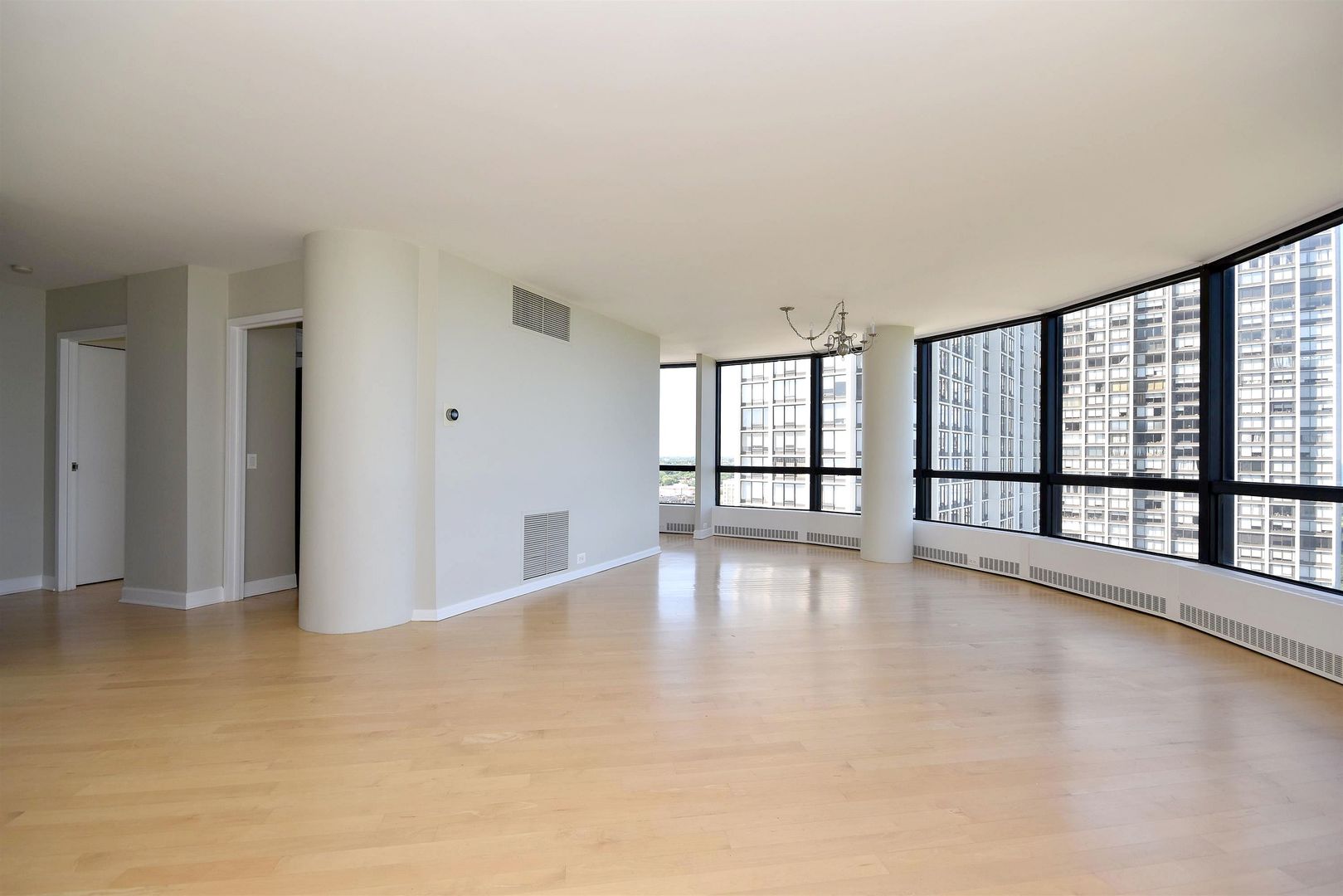 5415 North Sheridan Road, Unit 1806 Chicago, IL 60640 - Photo 15 of 38 wooden floor in an empty room with a window