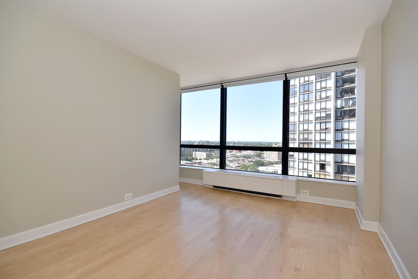 5415 North Sheridan Road, Unit 1806 Chicago, IL 60640 - Photo 22 of 38 wooden floor in an empty room with a window