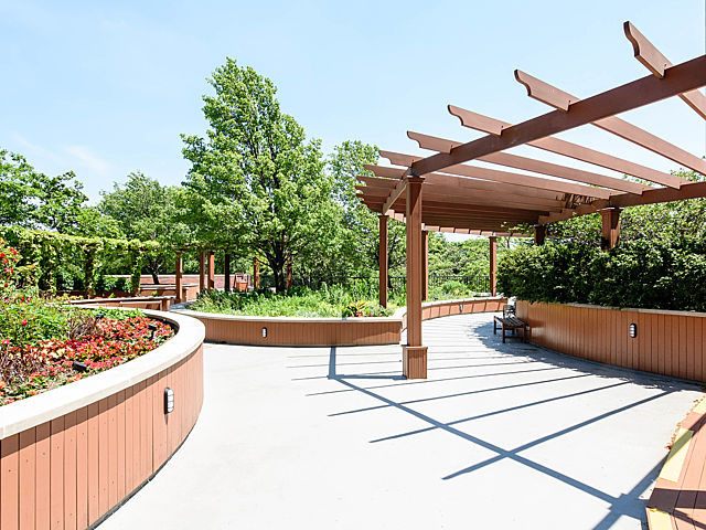 5415 North Sheridan Road, Unit 1806 Chicago, IL 60640 - Photo 32 of 38 a view of a patio with a table and chairs under an umbrella with a small yard