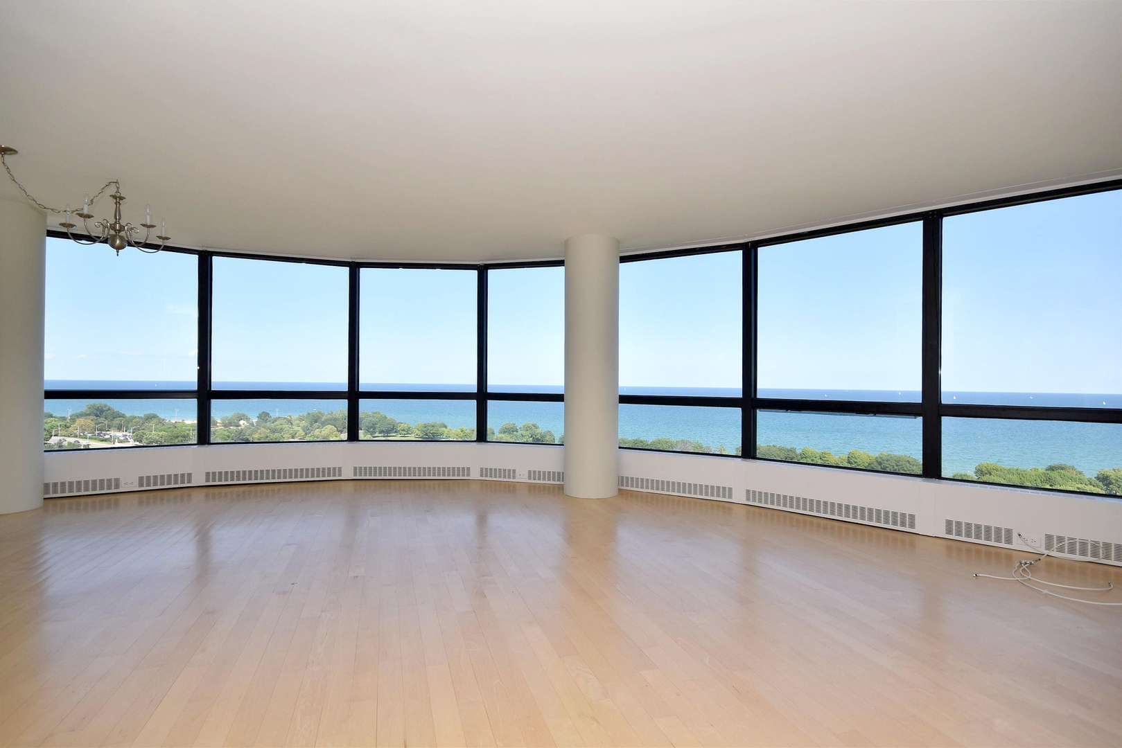5415 North Sheridan Road, Unit 1806 Chicago, IL 60640 - Photo 5 of 38 wooden floor in an empty room with a large window
