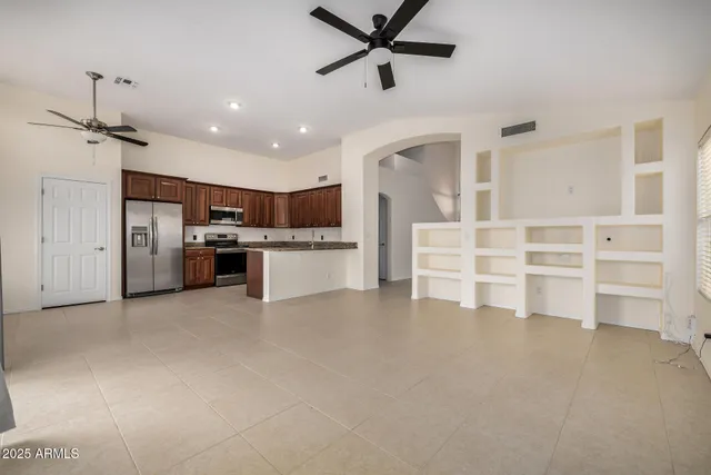 a view of kitchen with sink and refrigerator