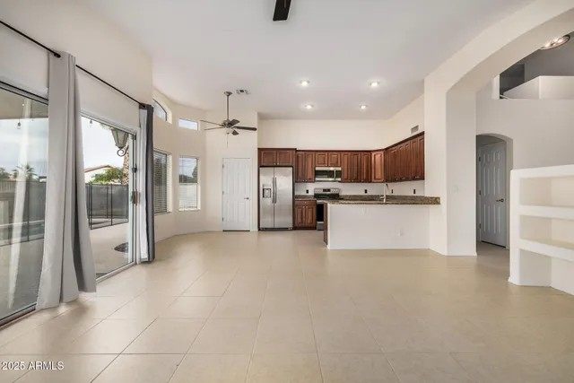 a view of a kitchen with refrigerator and a sink