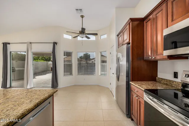 a kitchen with stainless steel appliances granite countertop a stove and a sink