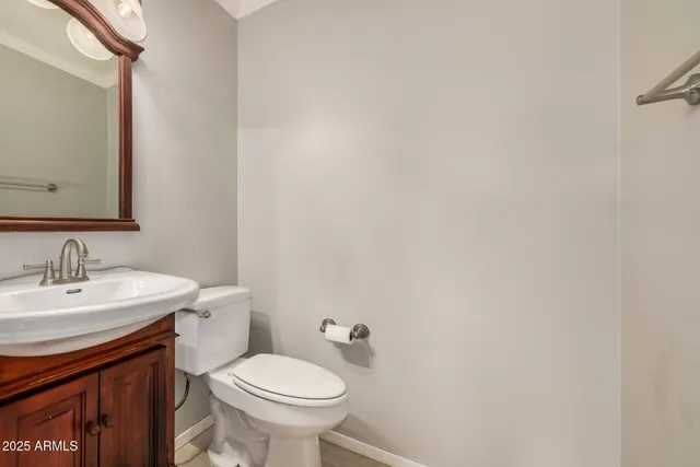 a bathroom with a sink a toilet and mirror