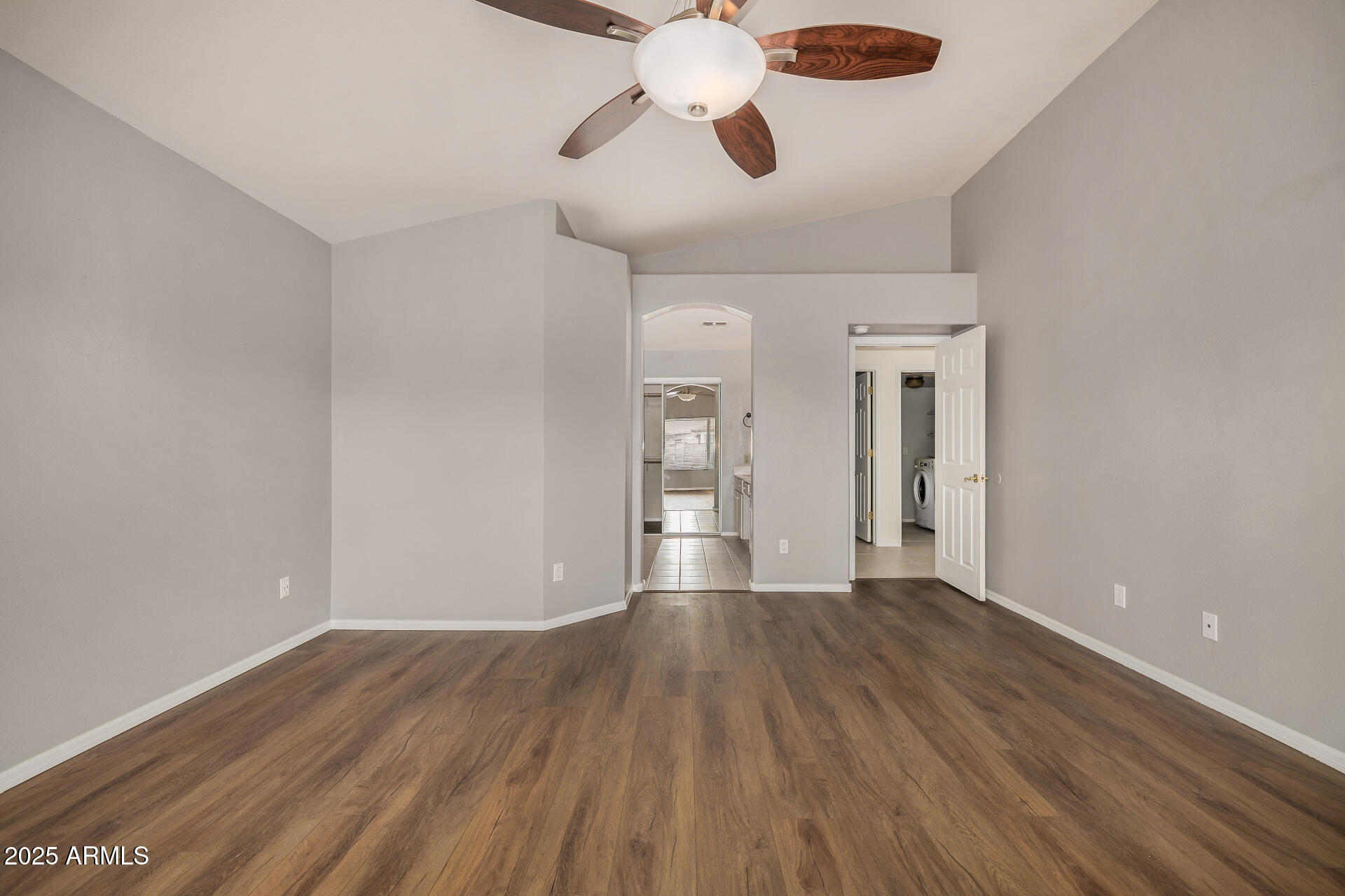 15002 South 47th Street Phoenix, AZ 85044 - Photo 19 of 41 a view of an empty room with wooden floor and a window