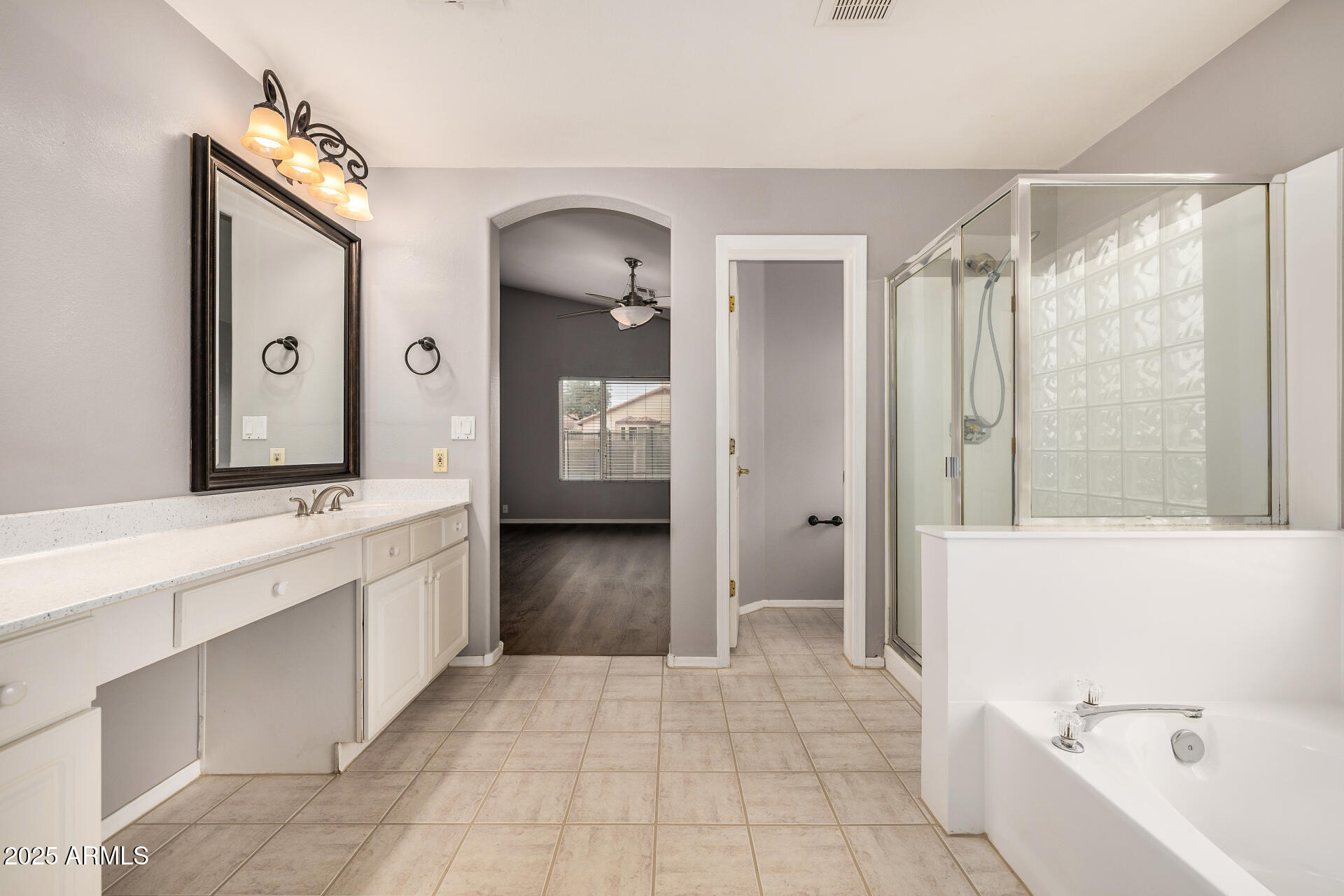 15002 South 47th Street Phoenix, AZ 85044 - Photo 22 of 41 a spacious bathroom with a bathtub sink and mirror
