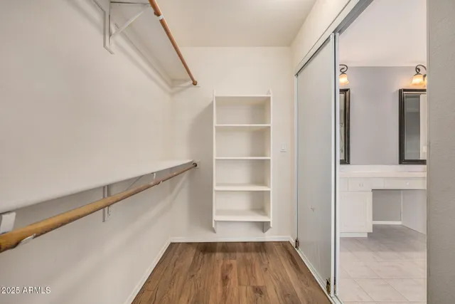 a view of walk in closet with empty racks