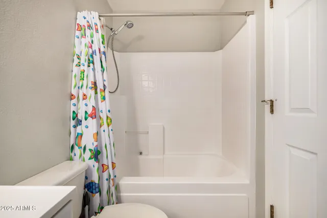 a bathroom with a shower curtain and a curtain