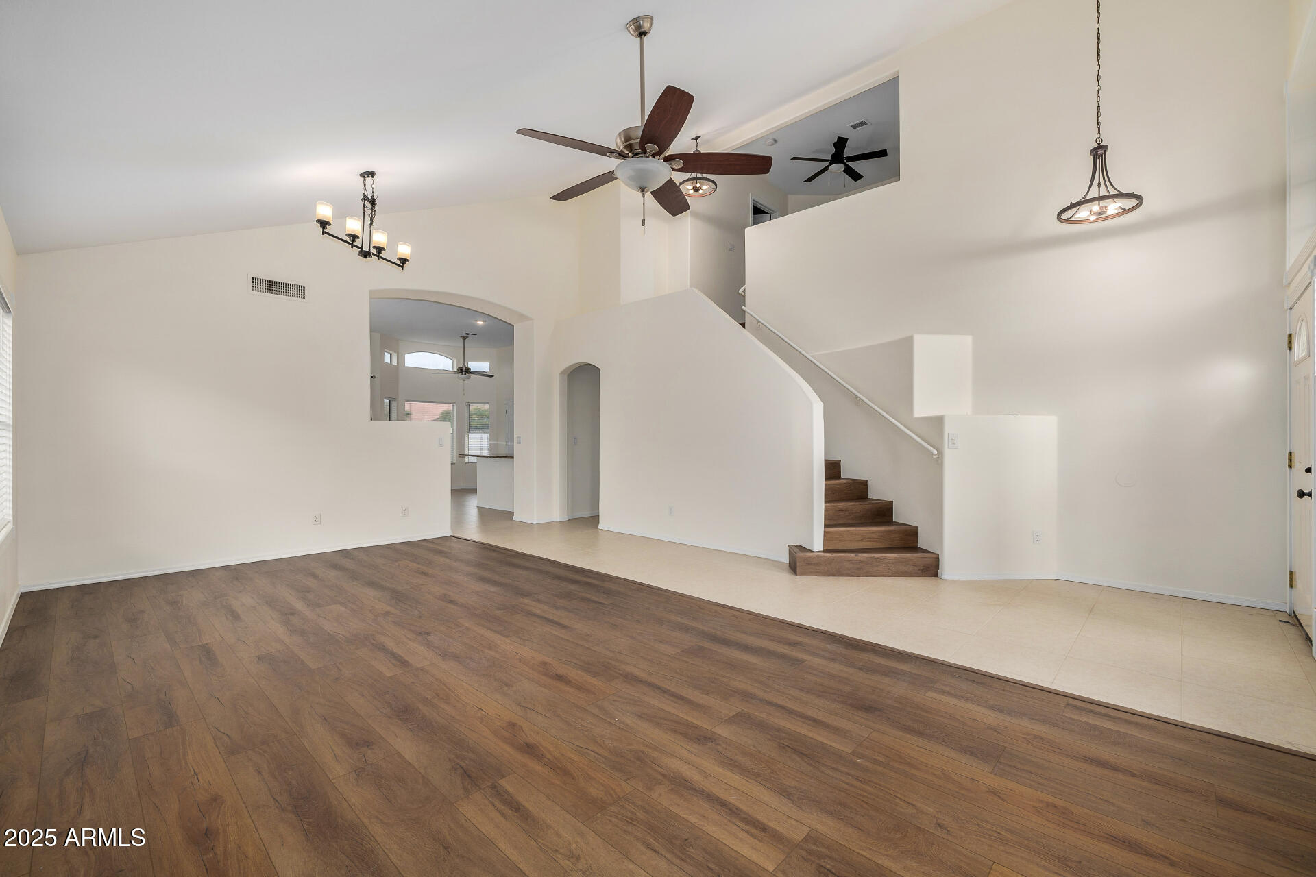 15002 South 47th Street Phoenix, AZ 85044 - Photo 9 of 41 a view of empty room with wooden floor and ceiling fan