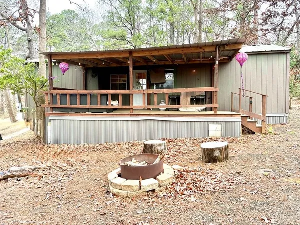 a view of a house with a yard and furniture