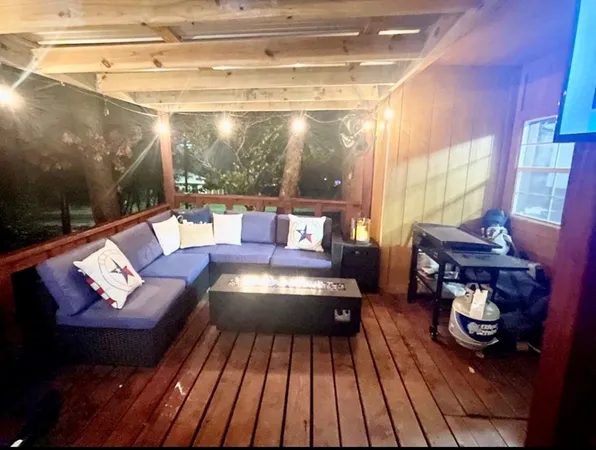 a living room with furniture and a floor to ceiling window