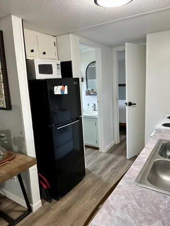 a kitchen with a refrigerator and cabinets